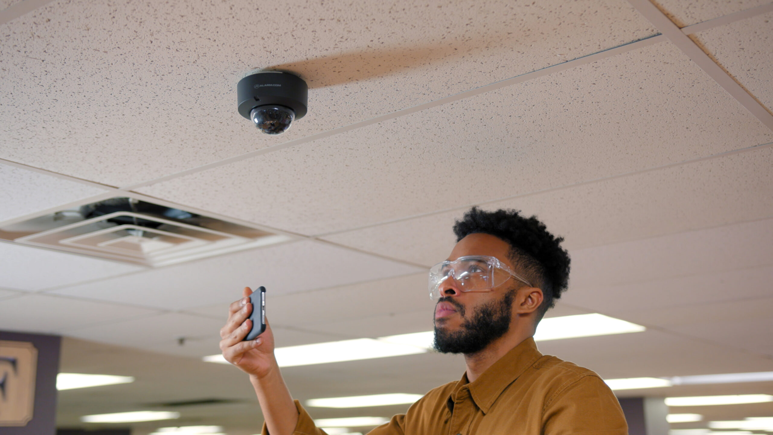 Man Monitoring Home Security on His Phone While On Vacation